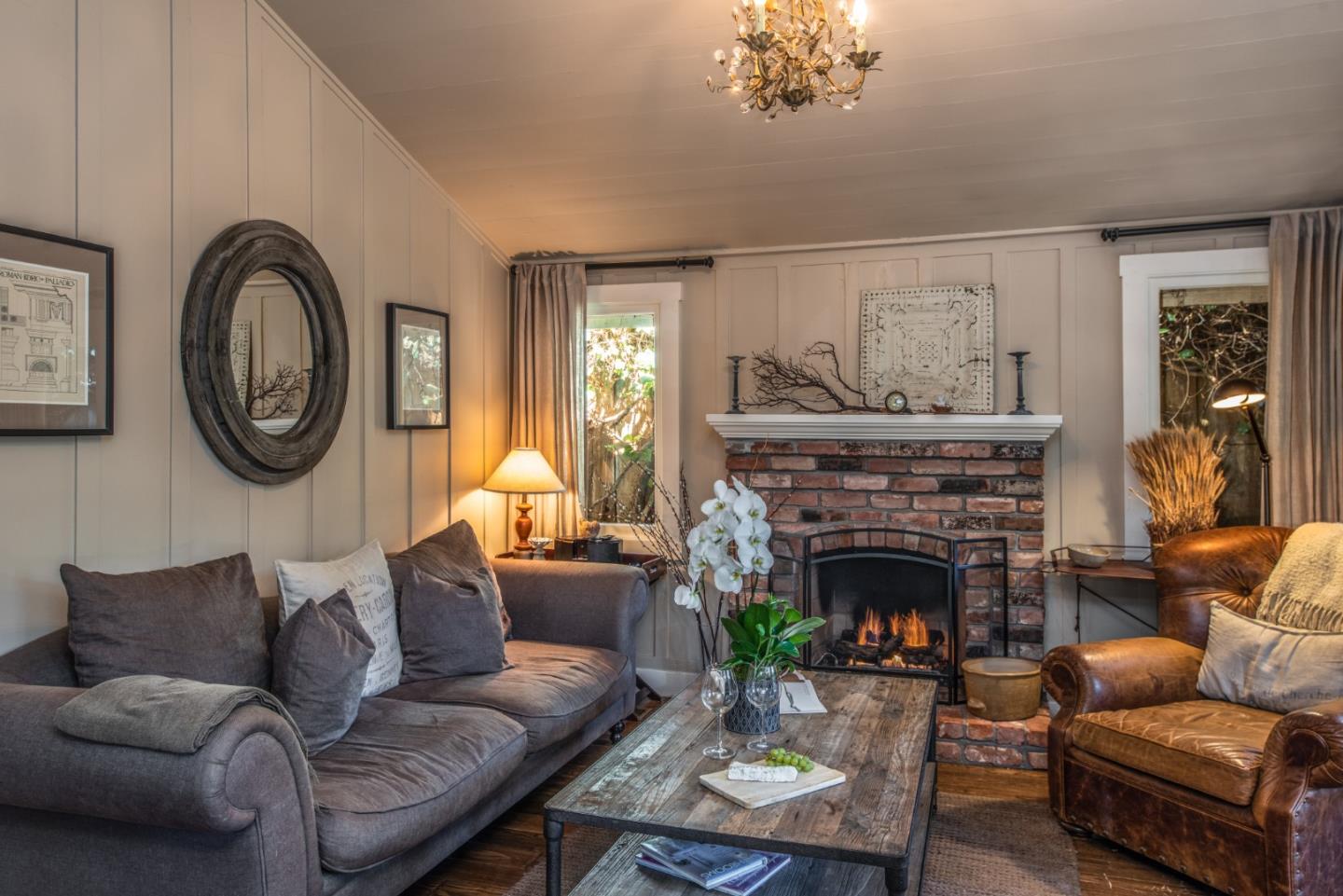 2- Carpenter & 3rd Street Carmel, CA 93921 - Photo 4 of 22 a living room with furniture a clock and a fireplace