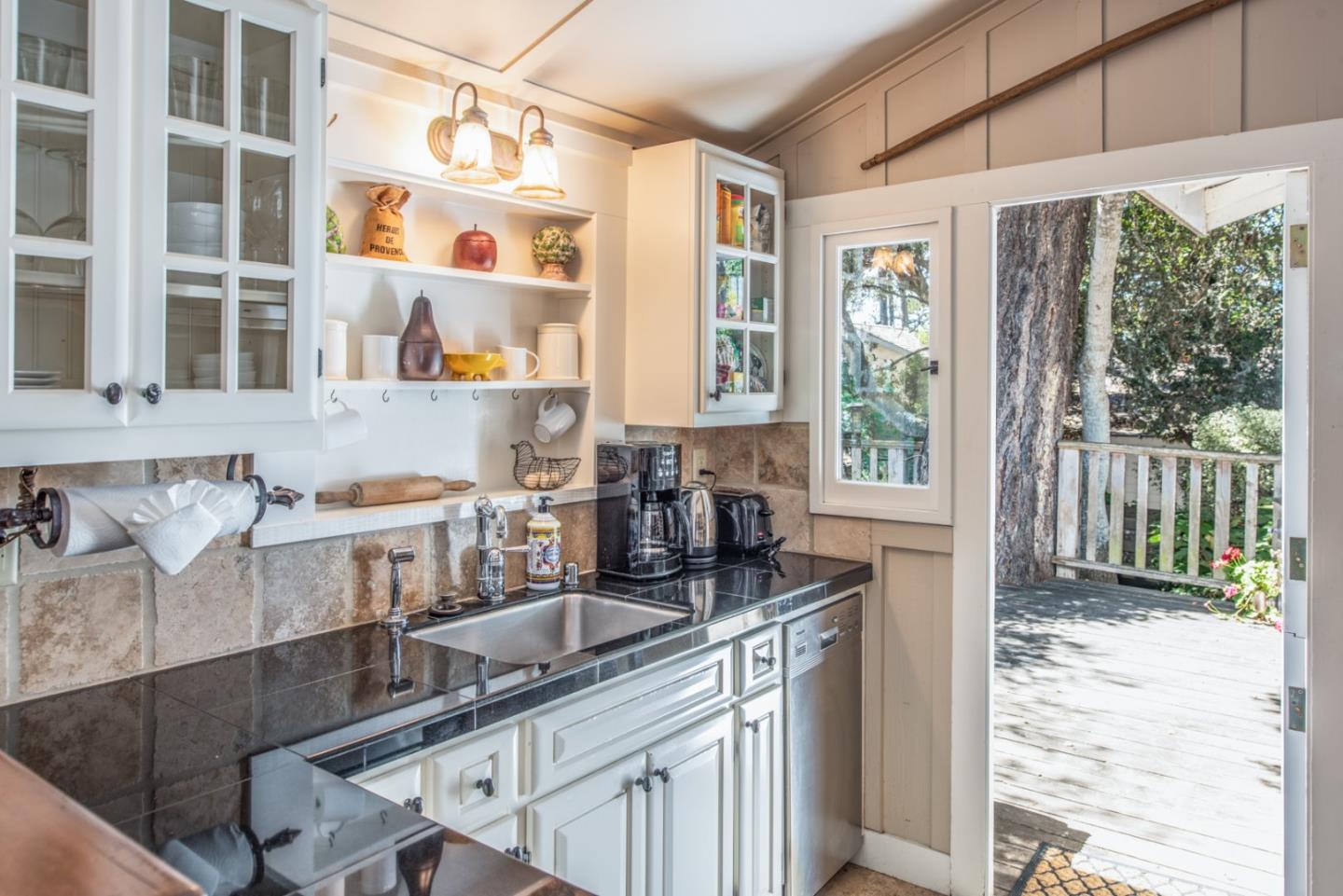 2- Carpenter & 3rd Street Carmel, CA 93921 - Photo 10 of 22 a kitchen with granite countertop a sink and a counter top space
