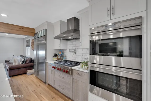 a living room with furniture and a painting on the wall
