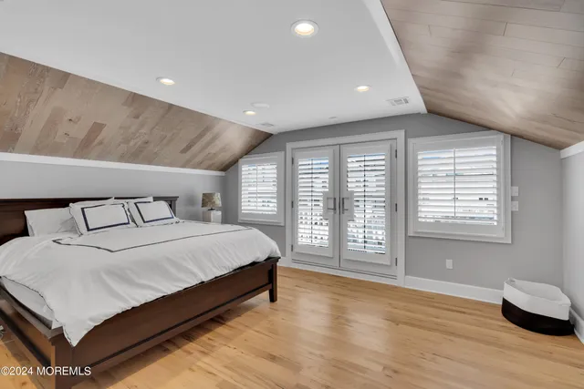 a bedroom with a bed and a large window