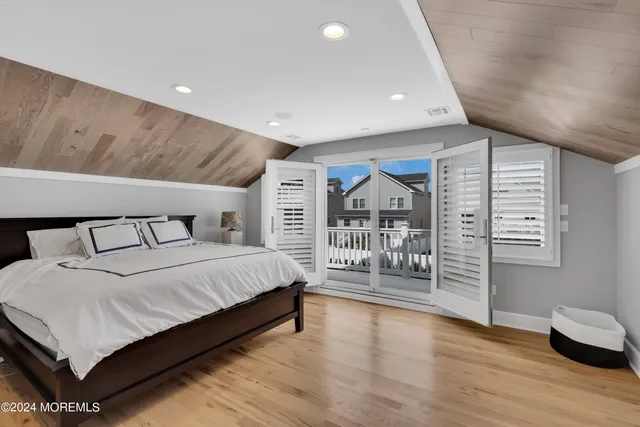 a view of a backyard with plants and a large tree