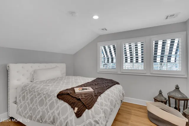 a front view of a house with a garden and plants