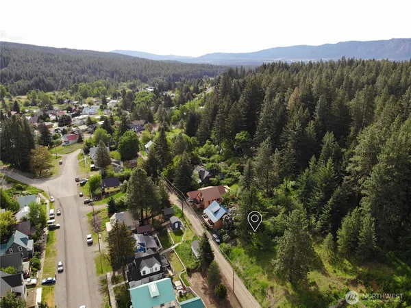 an aerial view of mountains residential house and green space