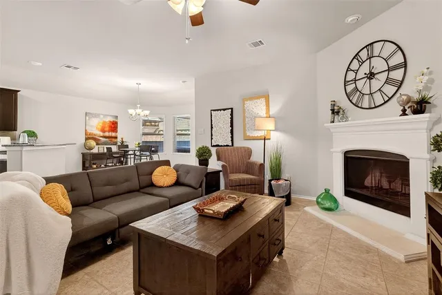 a living room with furniture a clock and a fireplace