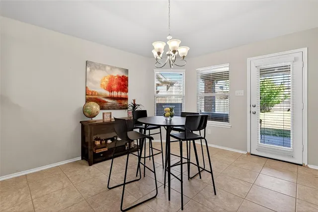 a view of a dining room with furniture and chandelier