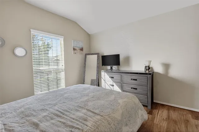a bedroom with a bed and flat screen tv