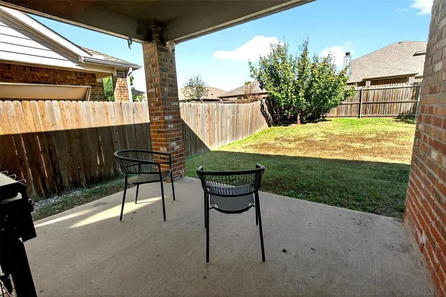 a view of a chair and table in the patio
