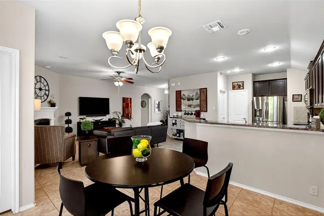 a view of a dining room with furniture and a kitchen