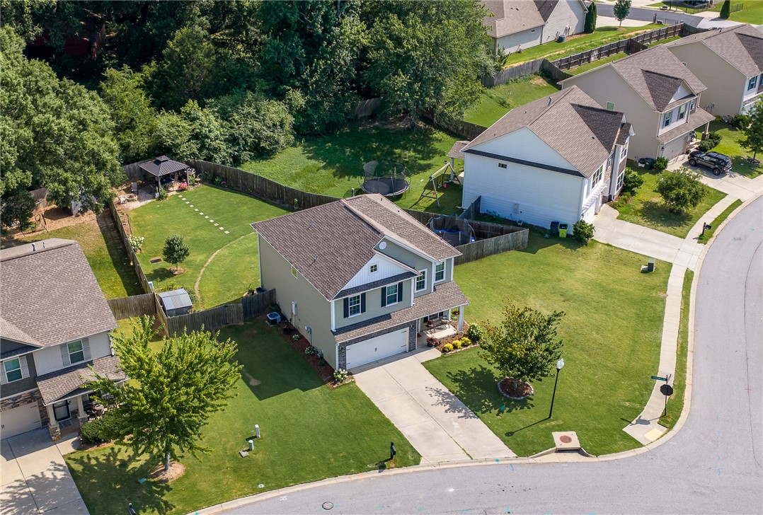 719 Camberwell Road Simpsonville, SC 29680 - Photo 4 of 47 A spacious suburban lot features a manicured green lawn bordering a curving paved street.