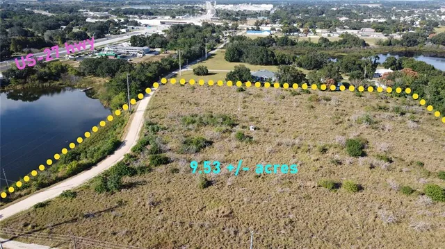 a view of a dry yard with wooden fence