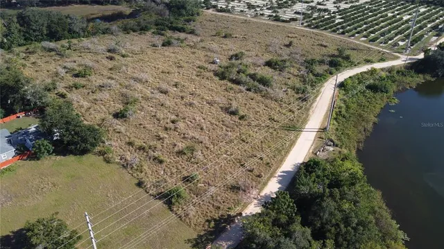 a view of a pathway with a flower garden