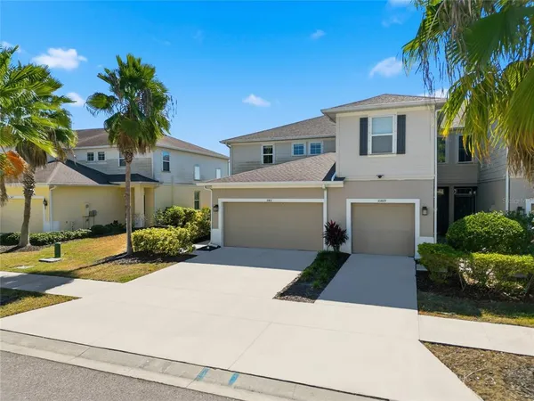 a front view of a house with a yard and garage