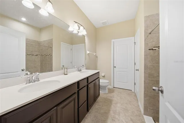 a spacious bathroom with a double vanity sink mirror and double