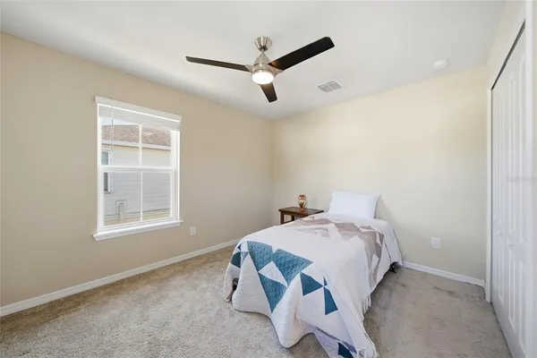 a bedroom with a bed and a window