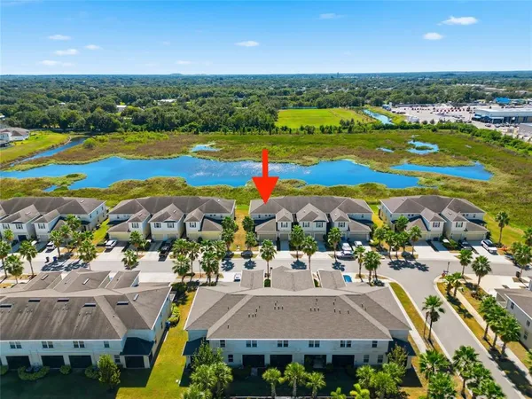 an aerial view of residential houses with outdoor space
