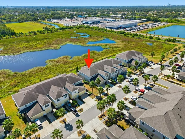 an aerial view of residential houses with outdoor space and ocean view