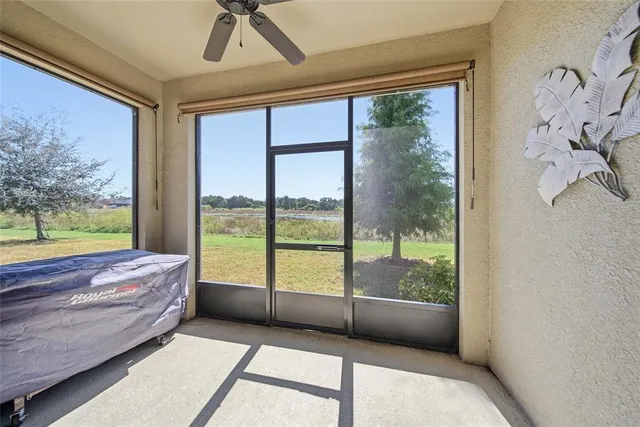 a bedroom with furniture and large windows
