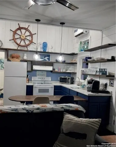 a kitchen with stainless steel appliances granite countertop a sink dishwasher stove and cabinets