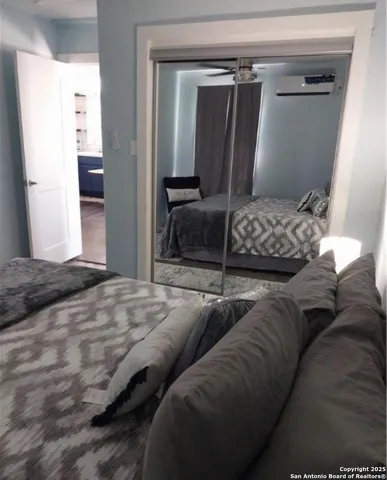 a bedroom with furniture and a window