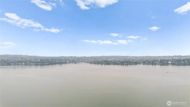 a view of a lake with houses in the back