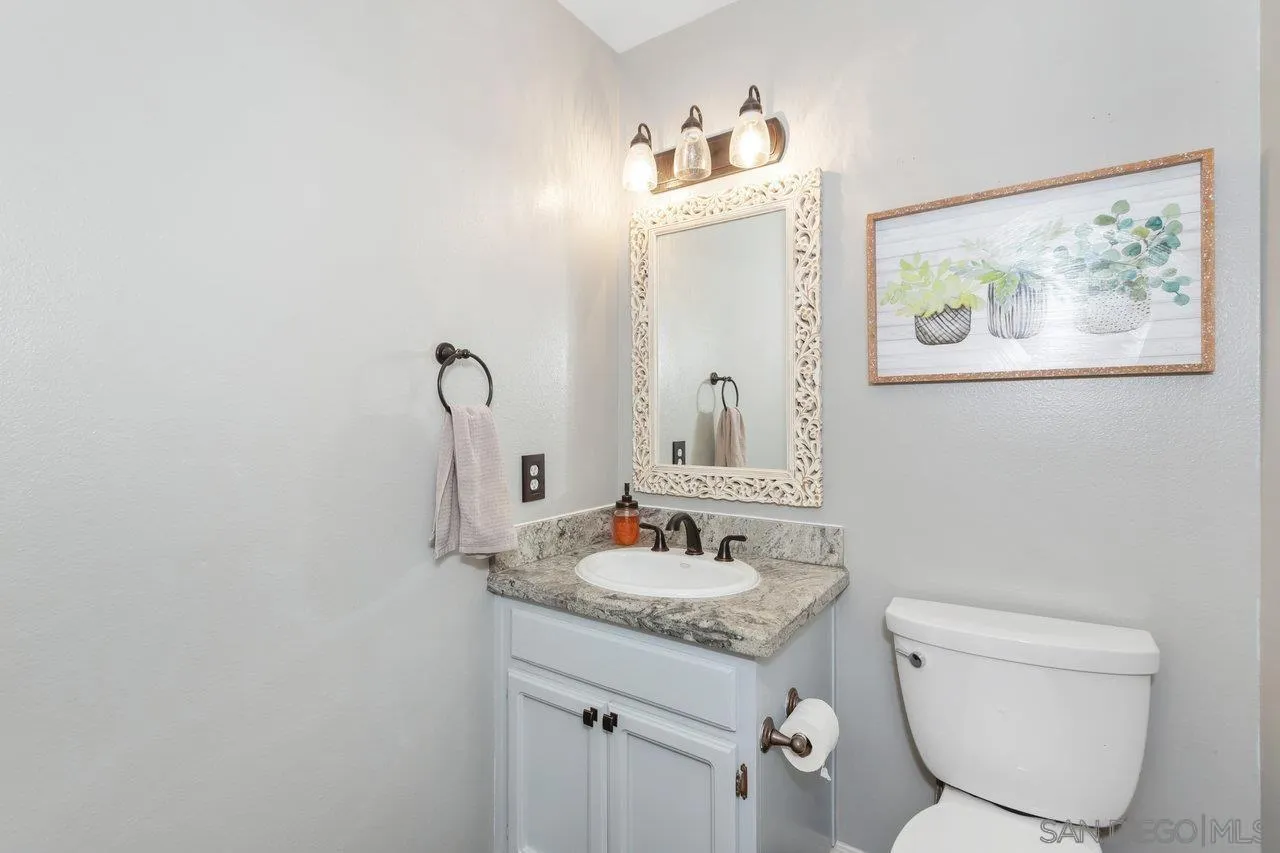 28423 Wimbleton Lane Escondido, CA 92026 - Photo 13 of 25 a bathroom with a toilet sink and mirror