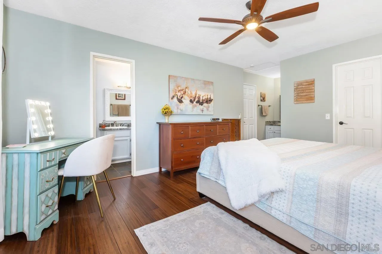 28423 Wimbleton Lane Escondido, CA 92026 - Photo 16 of 25 a spacious bedroom with a bed and a table in it