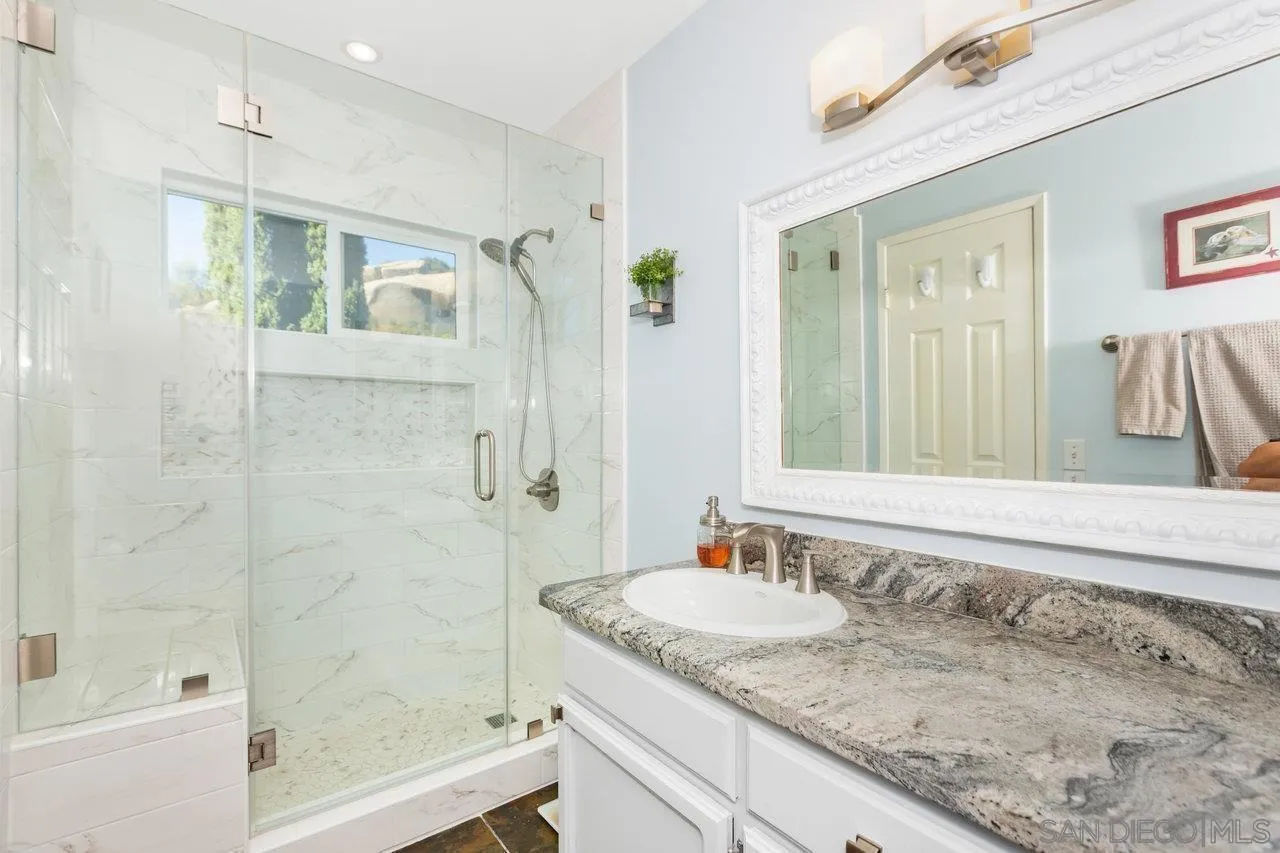 28423 Wimbleton Lane Escondido, CA 92026 - Photo 17 of 25 a bathroom with a granite countertop sink and a mirror