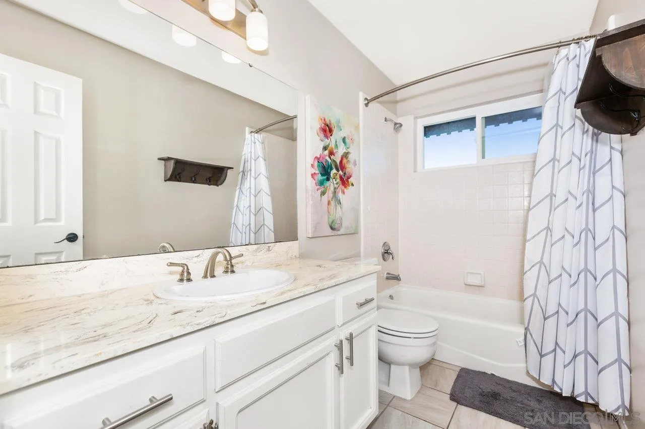 28423 Wimbleton Lane Escondido, CA 92026 - Photo 20 of 25 a bathroom with a granite countertop sink a toilet and a bathtub
