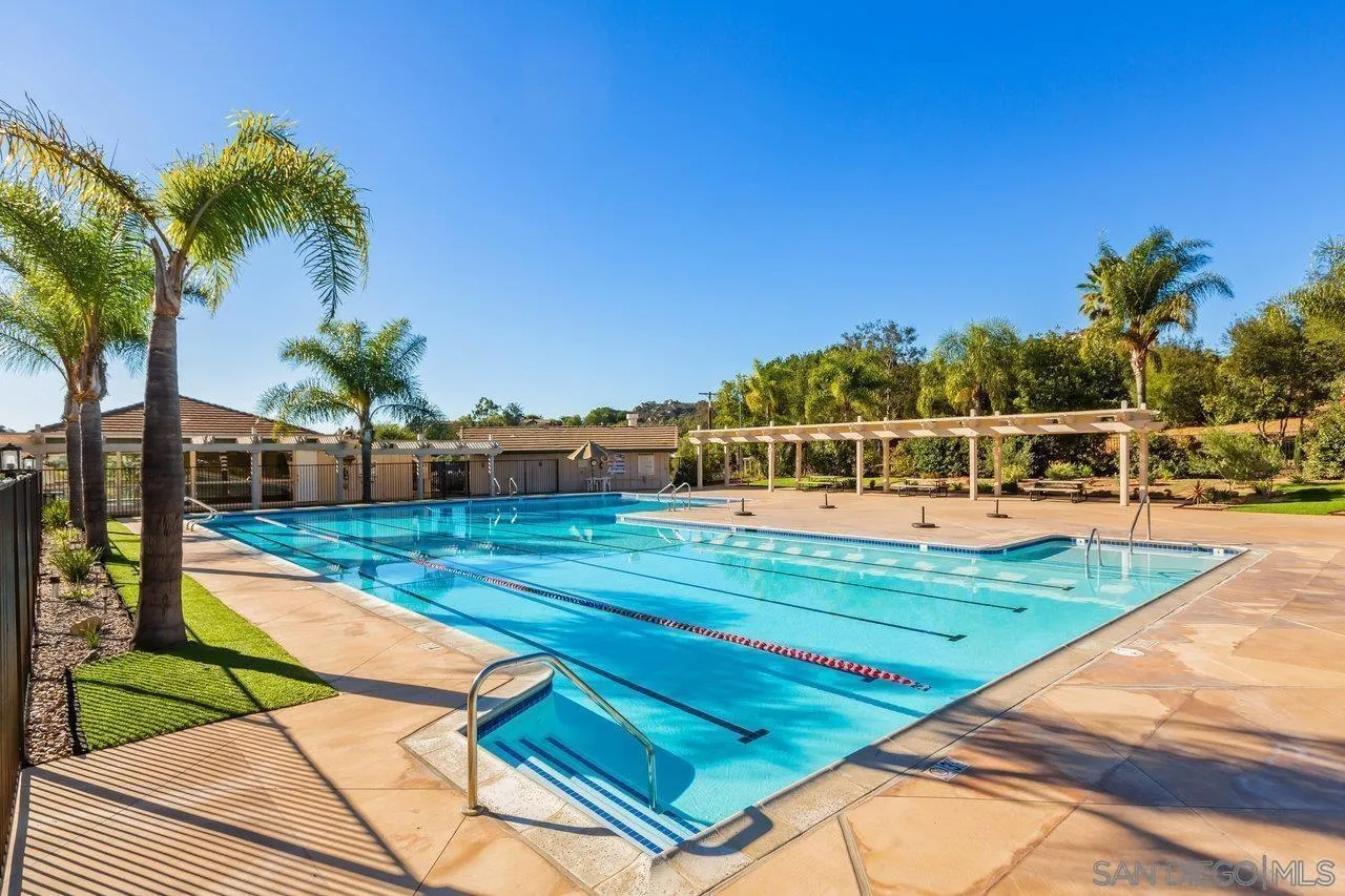28423 Wimbleton Lane Escondido, CA 92026 - Photo 25 of 25 a view of a swimming pool with a yard and palm trees