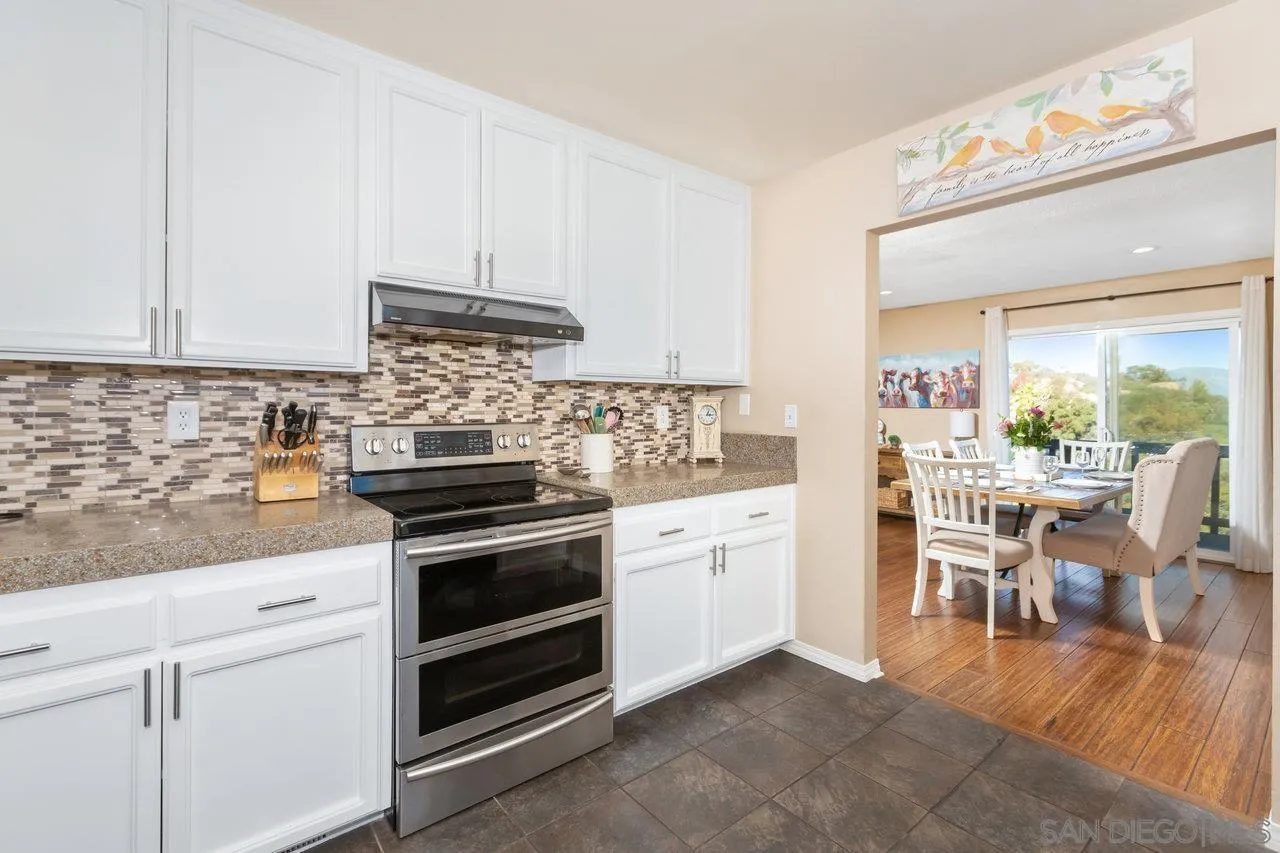 28423 Wimbleton Lane Escondido, CA 92026 - Photo 8 of 25 a kitchen with granite countertop cabinets stainless steel appliances and a dining table