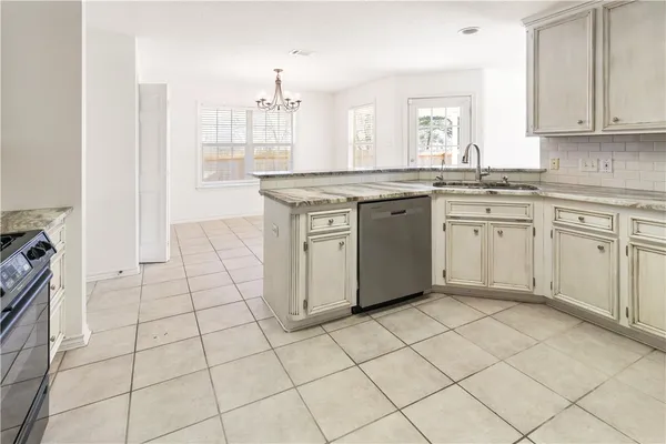 a kitchen with stainless steel appliances granite countertop a stove sink and cabinets