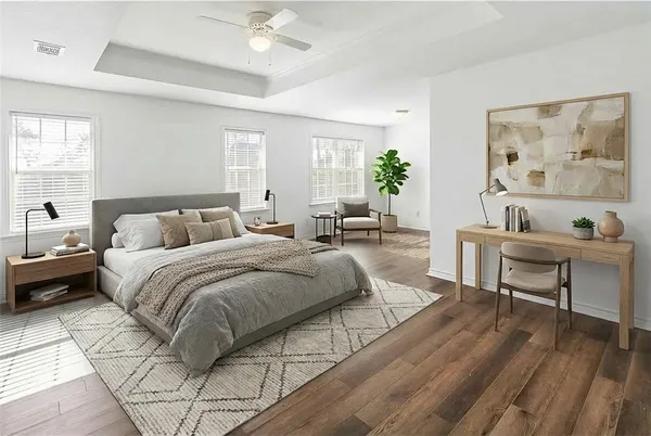 a spacious bedroom with a bed and a table