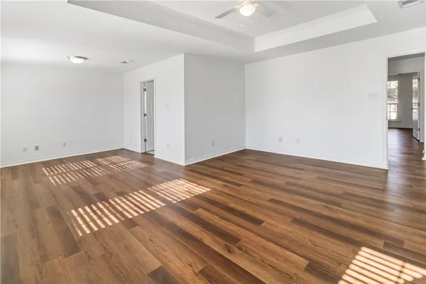 a view of a room with wooden floor