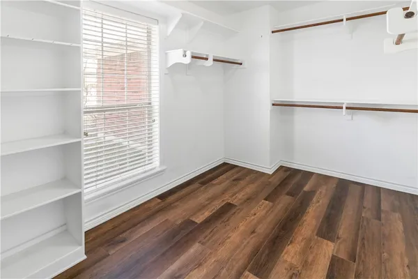 a view of a room with wooden floor and cabinet