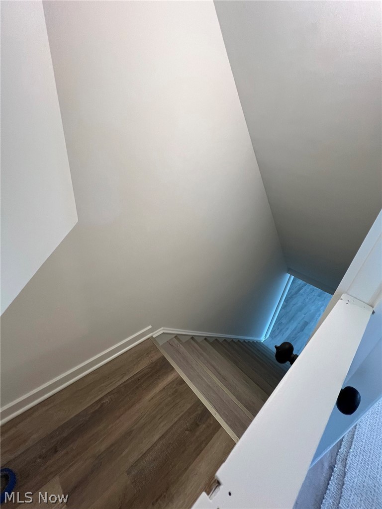 550 Johnson Road Wadsworth, OH 44281 - Photo 32 of 40 Stairway featuring vaulted ceiling and dark wood-type flooring