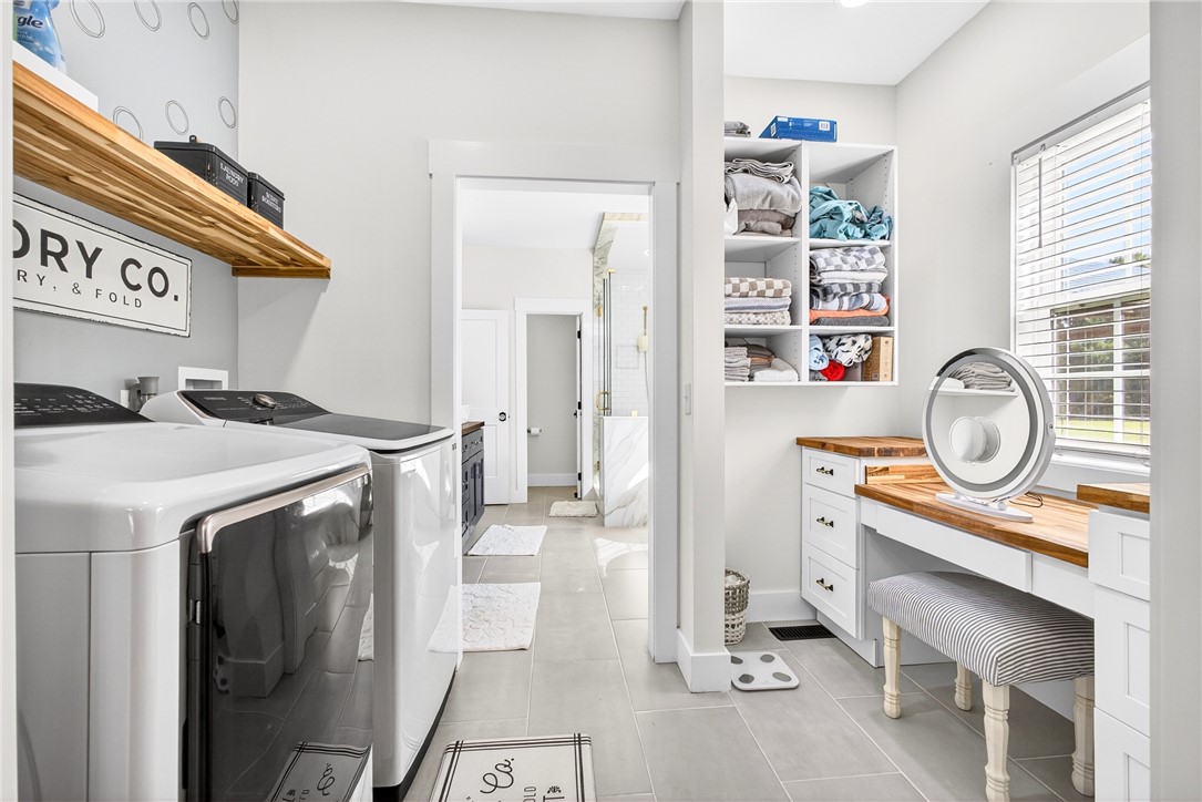 5016 Copeland Road Belton, SC 29627 - Photo 21 of 45 A well-appointed laundry room with modern appliances offers practical elegance and seamless access to a luxurious primary bathroom.