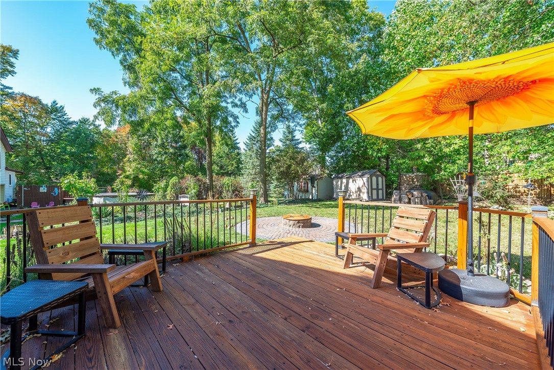 75 Houghton Road Northfield, OH 44067 - Photo 35 of 48 Wood-finish deck with a black metal railing and wood-capped posts