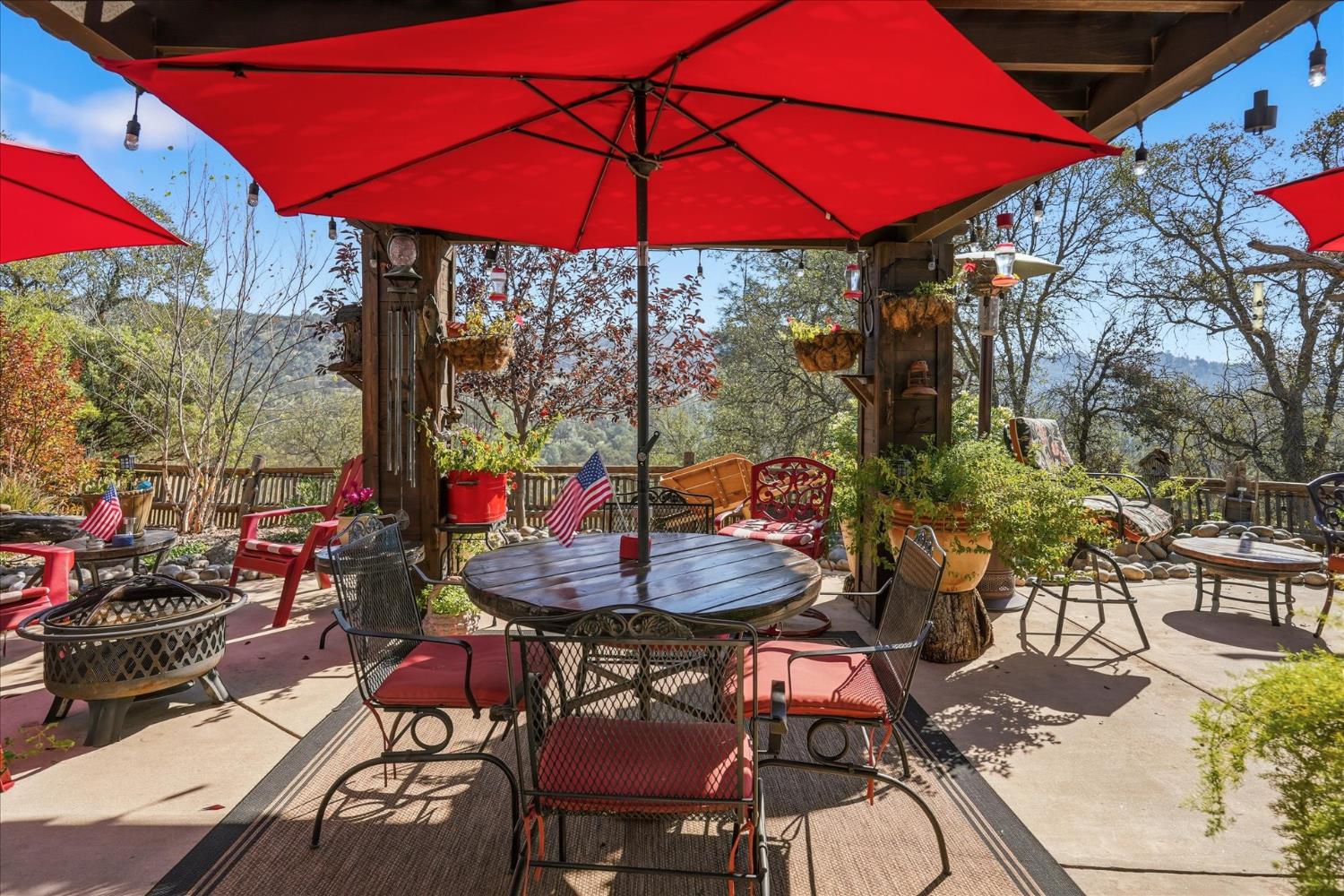 32583 River Knolls Road Coarsegold, CA 93614 - Photo 49 of 63 a view of a table and chairs under an umbrella