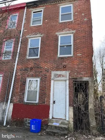a brick building with red door