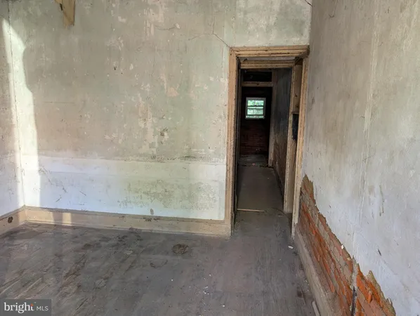 a view of an empty room and a window