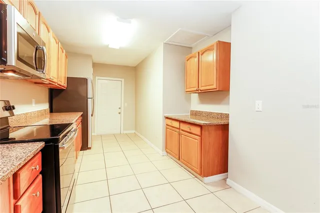 a kitchen with stainless steel appliances granite countertop a sink and cabinets