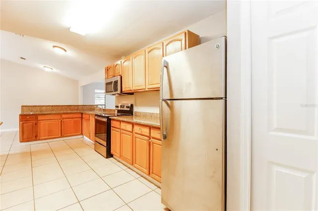 a kitchen with stainless steel appliances a refrigerator sink and cabinets