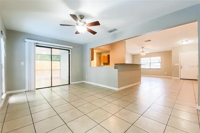 a view of a kitchen with furniture and an empty room