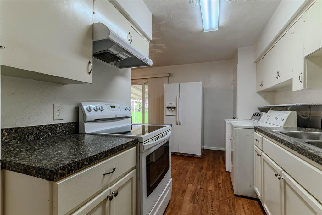 3213 Thames Street Irving, TX 75062 - Photo 12 of 25 a kitchen with stainless steel appliances granite countertop a sink a stove and a refrigerator