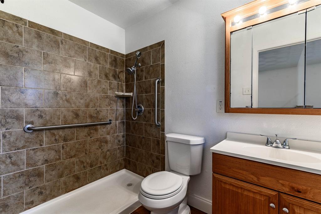 3213 Thames Street Irving, TX 75062 - Photo 16 of 25 a bathroom with a sink a toilet and shower