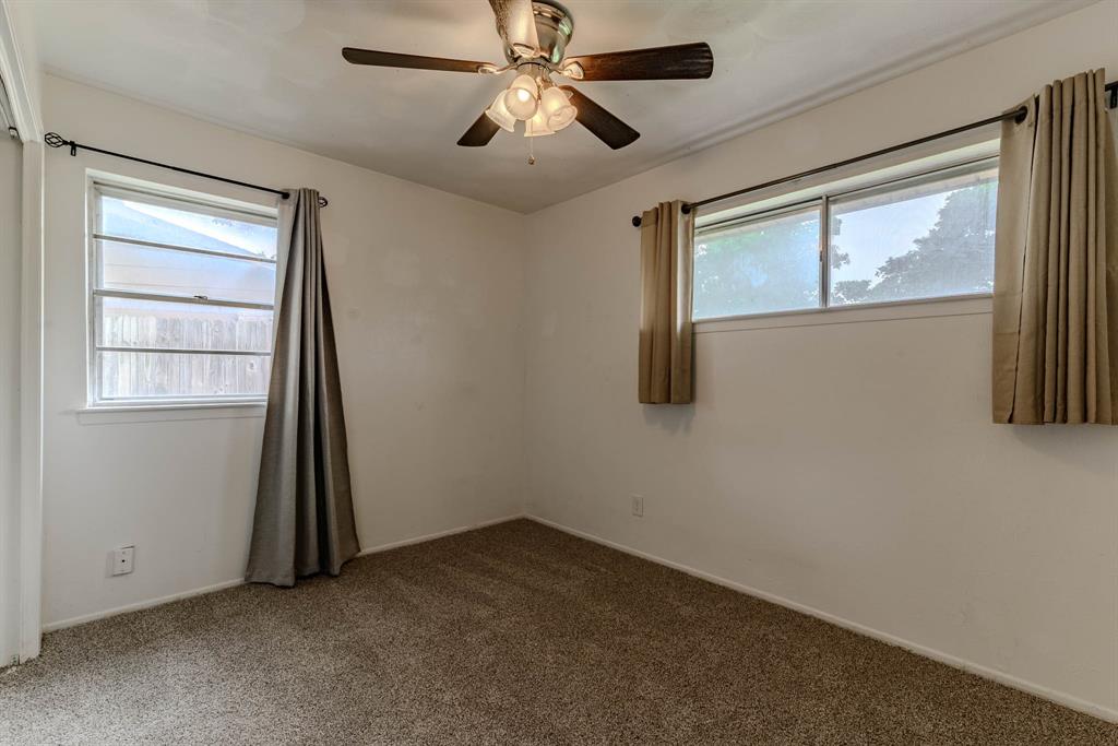 3213 Thames Street Irving, TX 75062 - Photo 17 of 25 an empty room with windows and closet