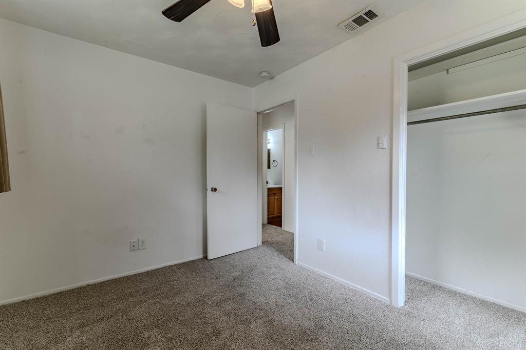 3213 Thames Street Irving, TX 75062 - Photo 18 of 25 an empty room with hallway closet and chandelier fan