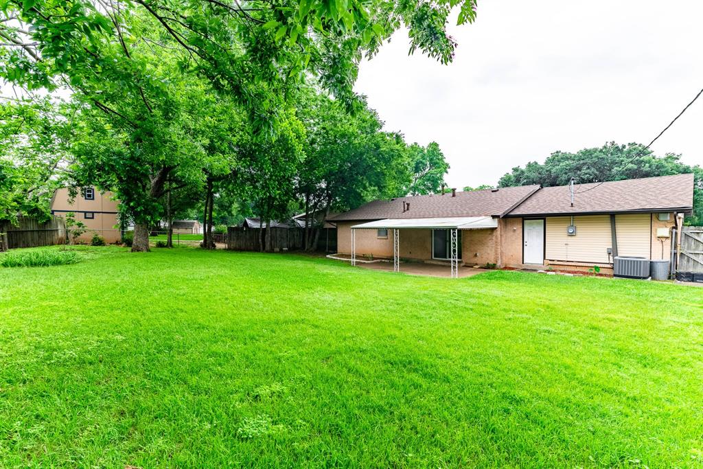 3213 Thames Street Irving, TX 75062 - Photo 23 of 25 a view of a house with backyard and garden