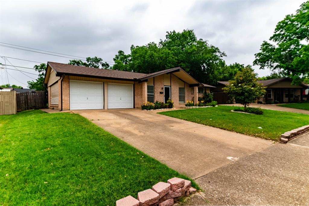 3213 Thames Street Irving, TX 75062 - Photo 3 of 25 a front view of a house with yard and green space