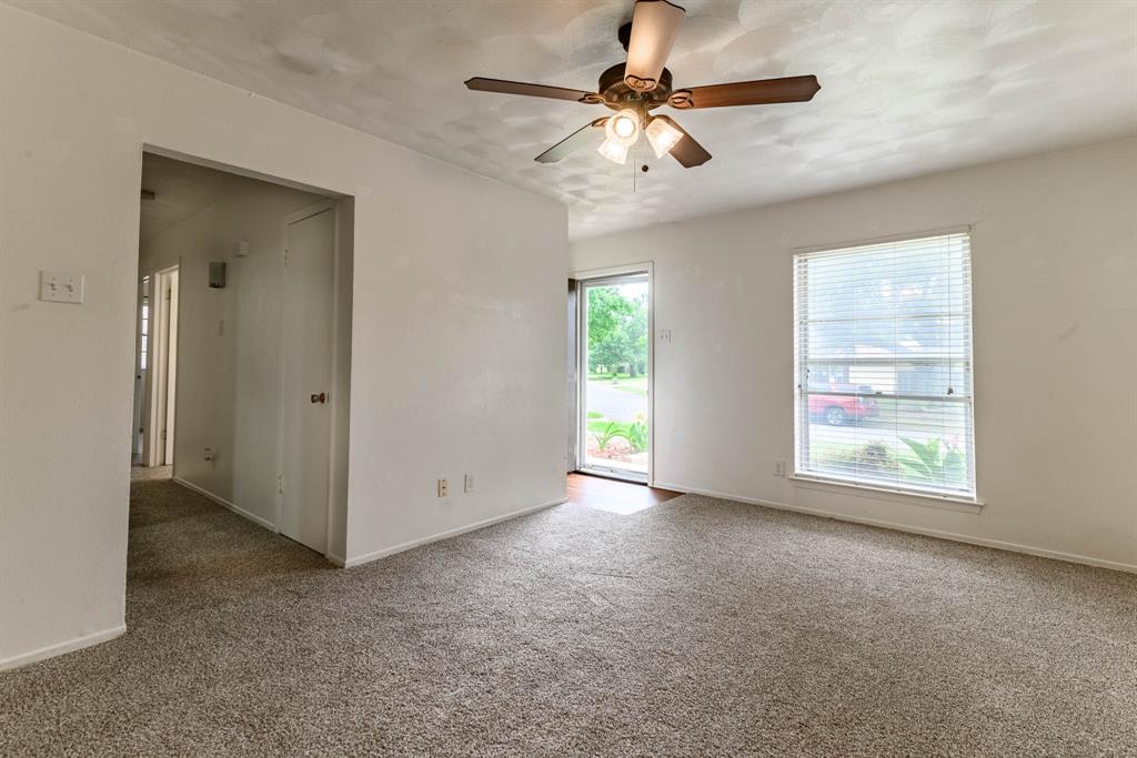 3213 Thames Street Irving, TX 75062 - Photo 6 of 25 an empty room with windows and fan
